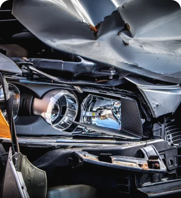 a front end of a car with a damaged front end