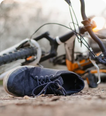 a shoe on the ground next to a bicycle