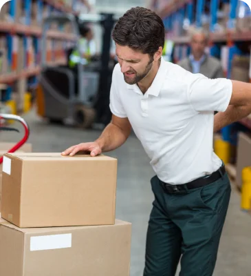 a man with back pain in a warehouse
