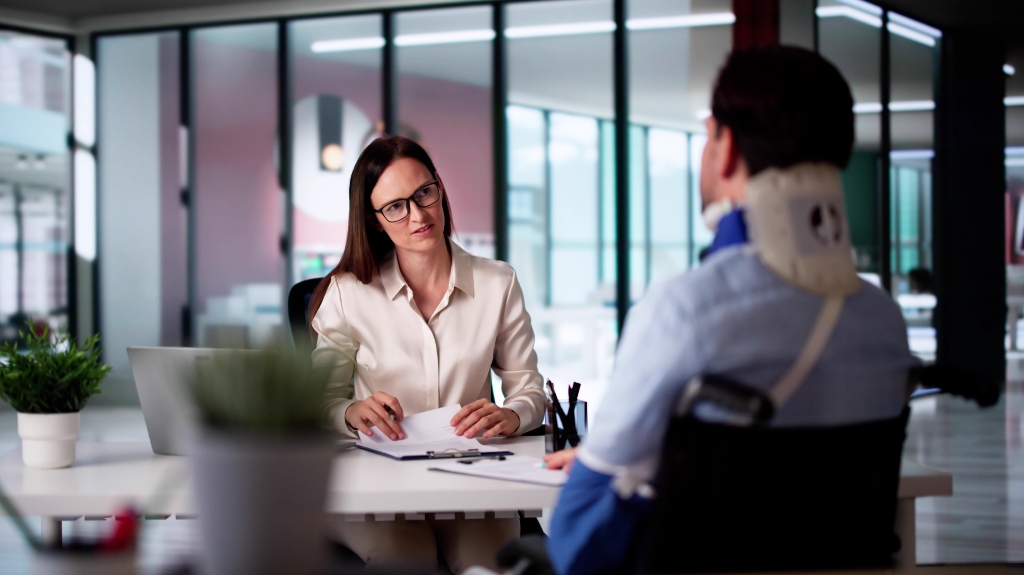 Client with personal injury consults with lawyer