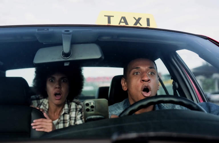 African American taxi driver and female passenger getting into accident on the road