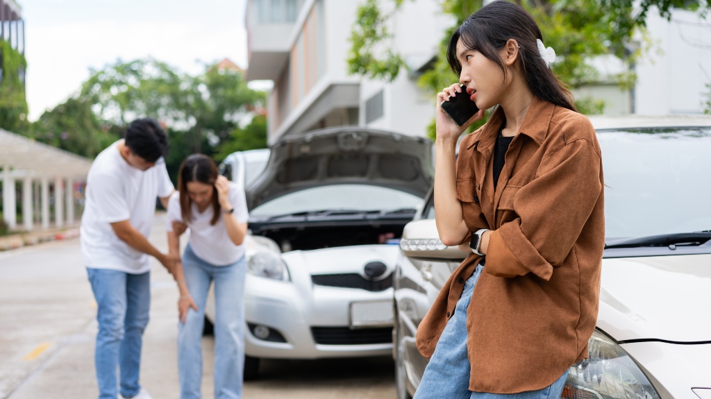 woman drivers call insurance after a car accident before taking pictures and sending insurance