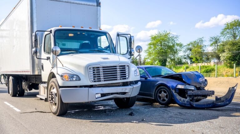 Collision of a semi truck with box trailer a passenger car on the highway road